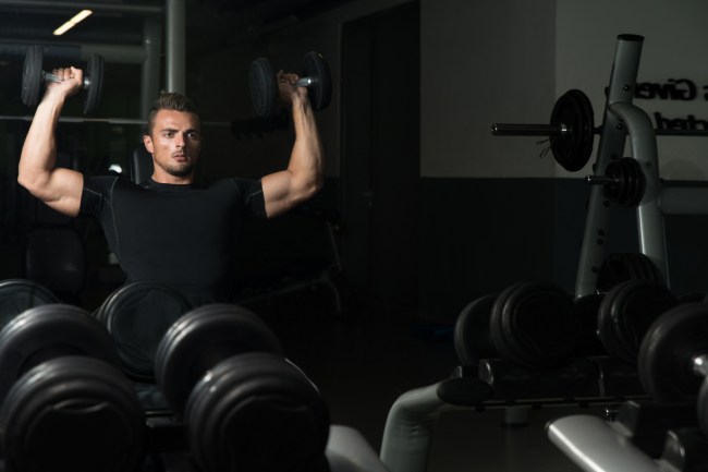 Young Men Doing Shoulder Press Whit Dumbbells
