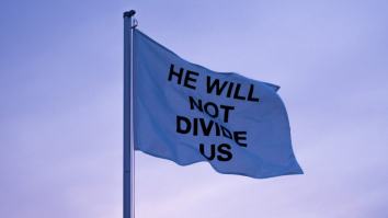 Shia LaBeouf Moved ‘He Will Not Divide Us’ Flag Overseas And It’s Already Down