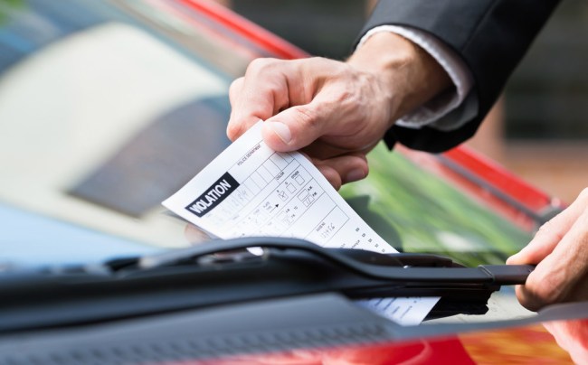 guy gets out parking ticket note windshield