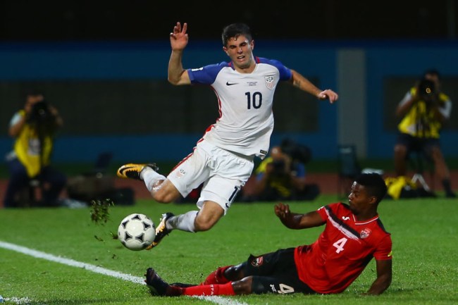 COUVA, TRINIDAD AND TOBAGO - OCTOBER 10: Christian Pulisic (L) of the United States mens national team is tackled by Kevon Villaroel (R) of Trinidad and Tobago during the FIFA World Cup Qualifier match between Trinidad and Tobago at the Ato Boldon Stadium on October 10, 2017 in Couva, Trinidad And Tobago.