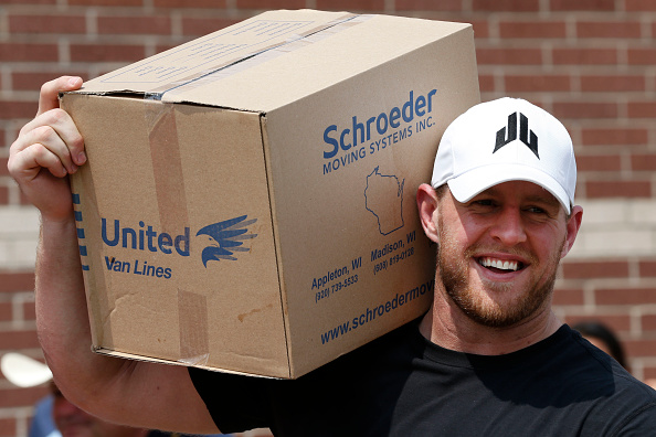 Houston Texans defensive end J.J. Watt holds a box of relief supplies on his shoulder while handing them out to people impacted by Hurricane Harvey