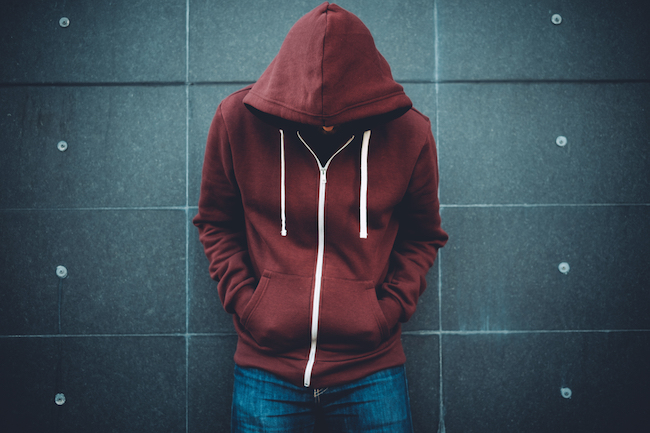 lonely guy standing against wall
