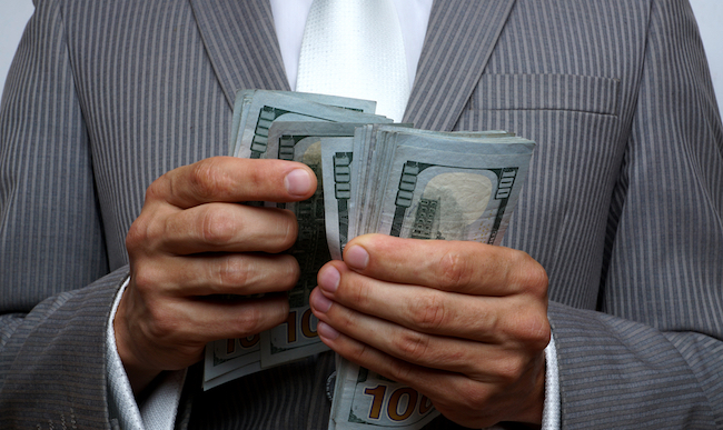 man in suit counting money