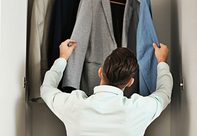 man looking in closet