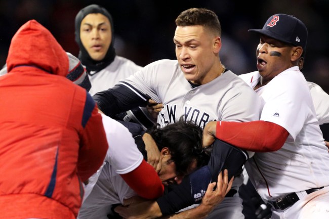 BOSTON, MA - APRIL 11: From top left, Giancarlo Stanton #27 of the New York Yankees, Aaron Judge #99 of the New York Yankees and Rafael Devers #11 of the Boston Red Sox separate Joe Kelly #56 of the Boston Red Sox, bottom, from Tyler Austin #26 of the New York Yankees, not pictured, during a fight in the seventh inning at Fenway Park on April 11, 2018 in Boston, Massachusetts. Austin rushed the mound after being struck by a pitch from Kelly.