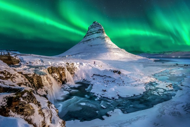 Iceland northern lights appear over Mount Kirkjufell in Iceland.