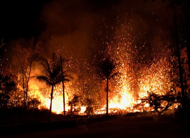 PAHOA, HI - MAY 5: In this handout photo provided by the U.S. Geological Survey, lava errupts from a new fissure from Luana Street after the eruption of Hawaii's Kilauea volcano on May 5, 2018 in the Leilani Estates subdivision near Pahoa, Hawaii. The governor of Hawaii has declared a local state of emergency near the Mount Kilauea volcano after it erupted following a 5.0-magnitude earthquake, forcing the evacuation of nearly 1,700 residents. (Photo by U.S. Geological Survey via Getty Images)