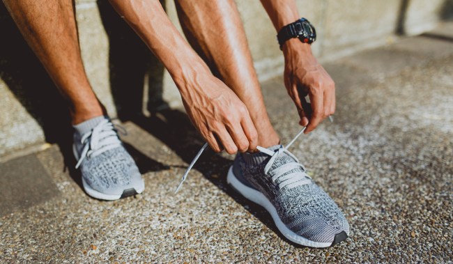 man tying his shoes