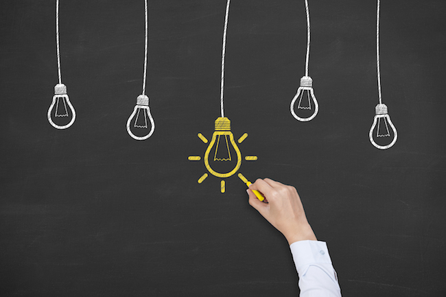Idea concept with light bulbs on a chalkboard background