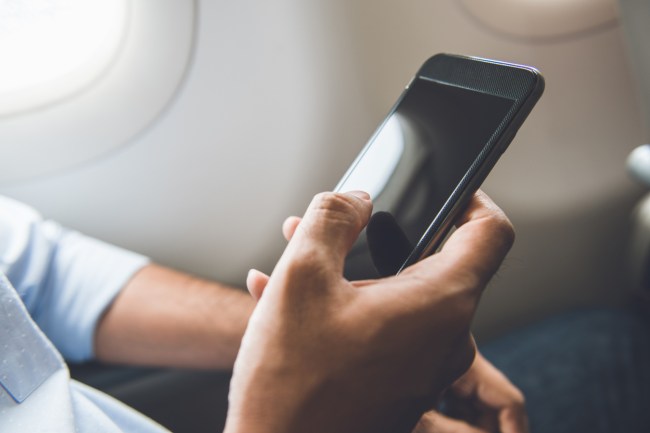 holding cellphone on airplane