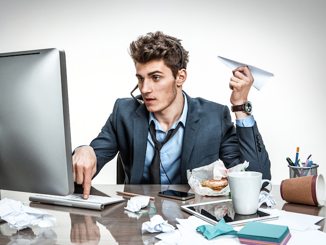 man at messy desk