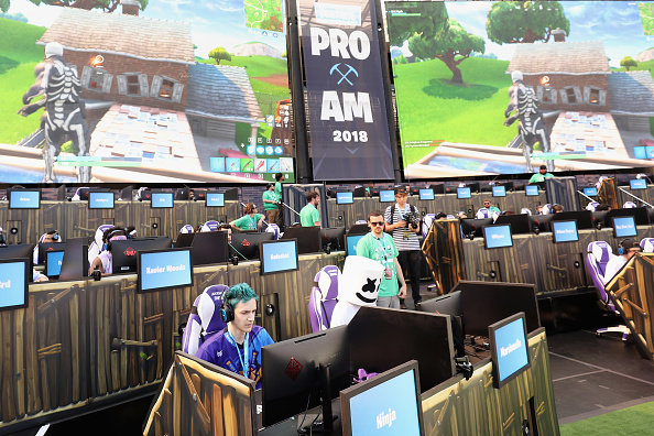 Gamers 'Ninja' (L) and 'Marshmello' compete in the Epic Games Fortnite E3 Tournament at the Banc of California Stadium on June 12, 2018 in Los Angeles, California.