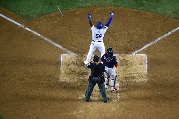 LOS ANGELES, CA - OCTOBER 27: Yasiel Puig #66 of the Los Angeles Dodgers hits a three-run home run in the sixth inning of Game Four of the 2018 World Series against pitcher Eduardo Rodriguez #57 of the Boston Red Sox (not in photo) at Dodger Stadium on October 27, 2018 in Los Angeles, California. (Photo by Harry How/Getty Images)