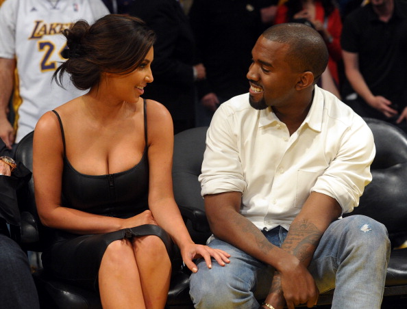 LOS ANGELES, CA - MAY 12: Kim Kardashian and Kanye West talk from their courtside seats before the Los Angeles Lakers take on the Denver Nuggets in Game Seven of the Western Conference Quarterfinals in the 2012 NBA Playoffs on May 12, 2012 at Staples Center in Los Angeles, California. (Photo by Noel Vasquez/Getty Images)