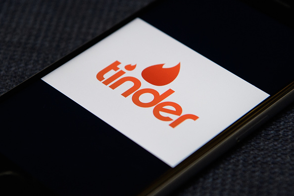 LONDON, ENGLAND - NOVEMBER 24:  The "Tinder" app logo is seen on a mobile phone screen on November 24, 2016 in London, England.  Following a number of deaths linked to the use of anonymous online dating apps, the police have warned users to be aware of the risks involved, following the growth in the scale of violence and sexual assaults linked to their use.  (Photo by Leon Neal/Getty Images)