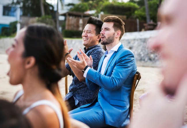 Guests attending a beach wedding ceremony