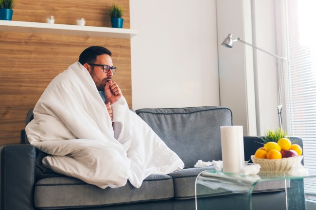 Young man suffering from cold and coughing