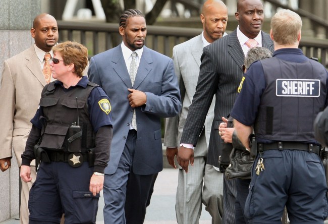CHICAGO - MAY 09:  R&B singer R. Kelly (3rd-L) leaves the Cook County courthouse where jury selection is underway for his child pornography trial May 9, 2008 in Chicago, Illinois. Kelly has been accused of videotaping himself having sex with a girl believed to be as young as 13 years old. Kelly faces up to 15 years in prison if convicted.  (Photo by Scott Olson/Getty Images)