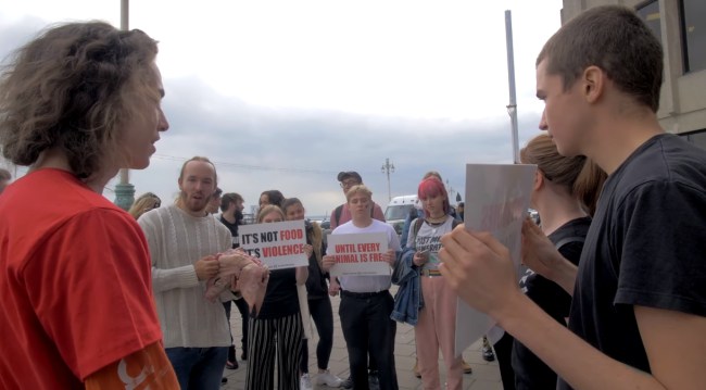 protester eats raw pig’s head outside vegan festival in stand-off with animal rights activists