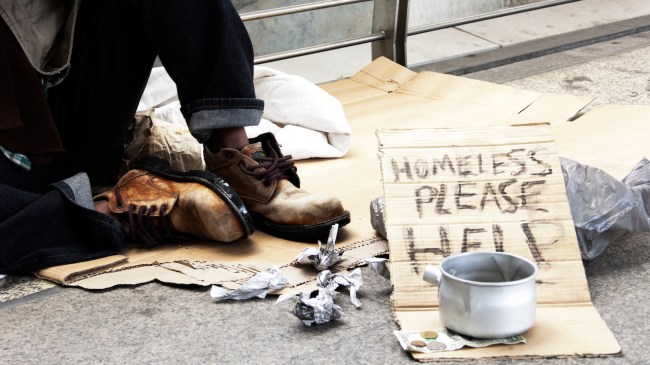homeless man donation on street in the capital city.