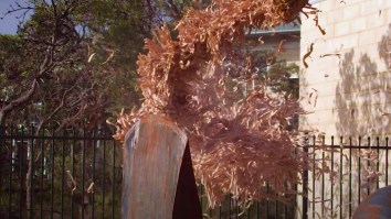 Enormous Rubber Band Ball Dropped From A 9-Story Tower Explodes On Top Of A Gigantic Axe