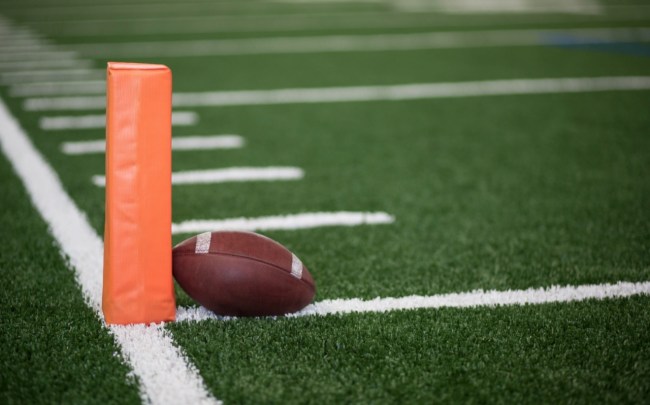 A football rests against a pylon.