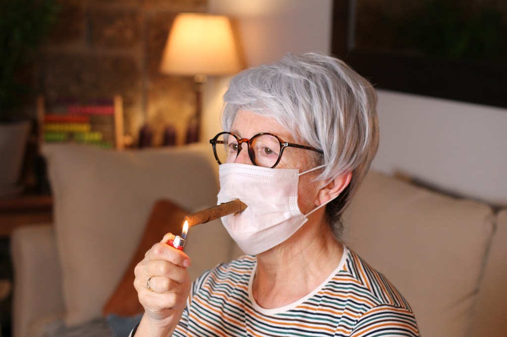elderly woman smoking a cigar