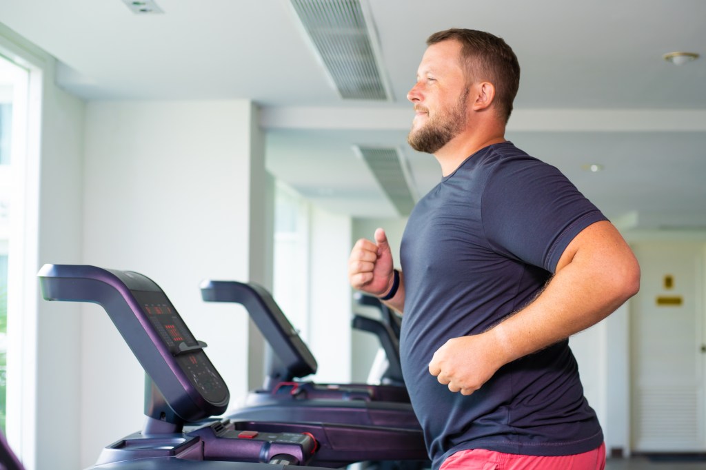 Dad Bod guy running on treadmill
