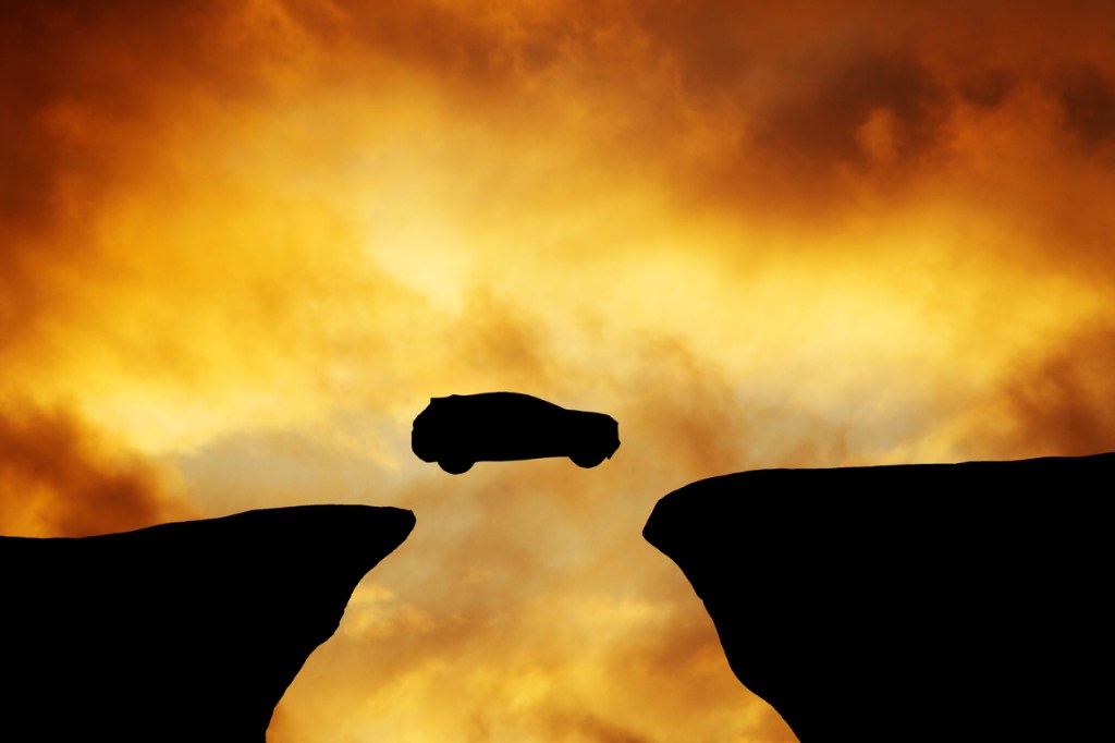 The Annual 'Car Huck' In Alaska Of Shooting Cars Off A Mountain Might Be The Coolest Event Ever