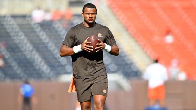 deshaun watson standing and holding a football
