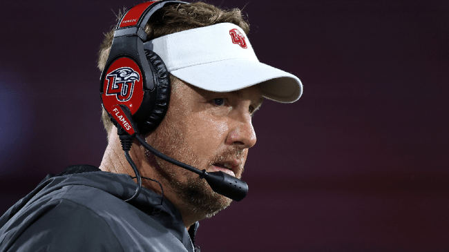 Hugh Freeze watches a game from the sidelines.