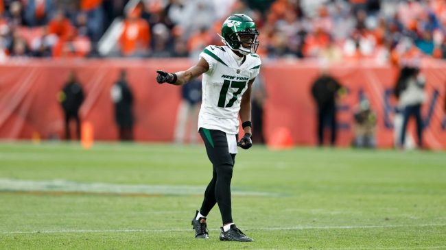 new york jets wide receiver garrett wilson wearing a white jersey and black pants