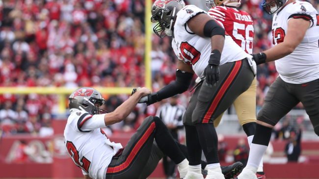 Tom Brady gets to his feet after being tackled.