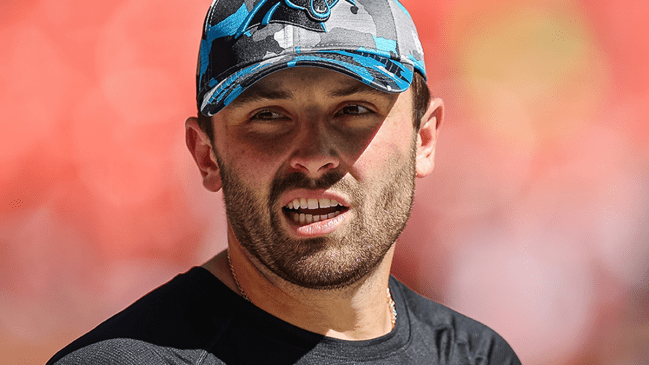 Baker Mayfield wearing a carolina panthers hat