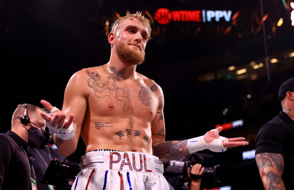 Jake Paul shrugs shoulders in boxing ring