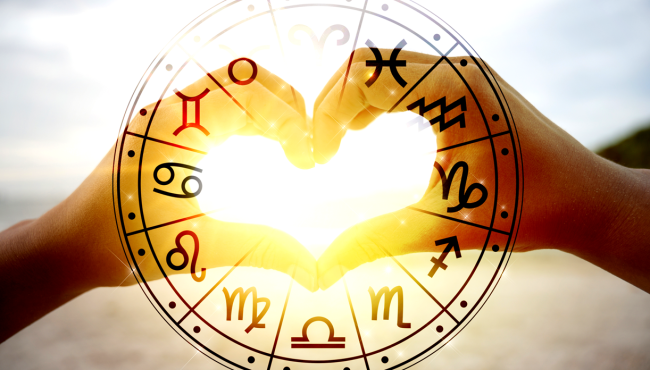 zodiac signs over two hands making a heart
