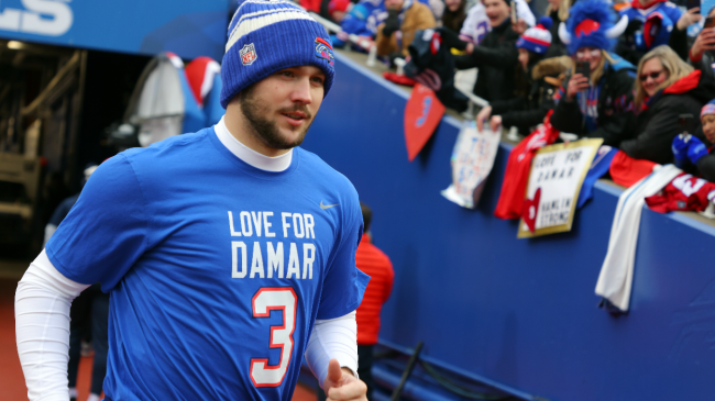 Josh Allen runs onto the field.