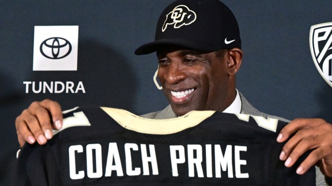 Colorado football coach Deion Sanders holding Coach Prime jersey