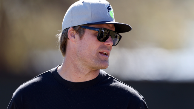 Greg Olsen talks on the sidelines.