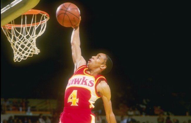 Spud Webb dunking a basketball