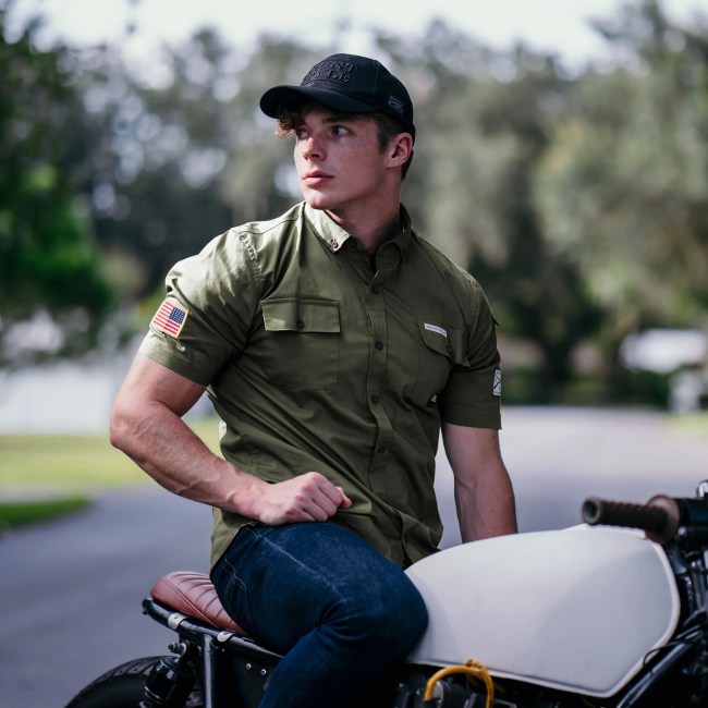 Man wearing a Grunt Style Button Down Garage Shirt in Military Green