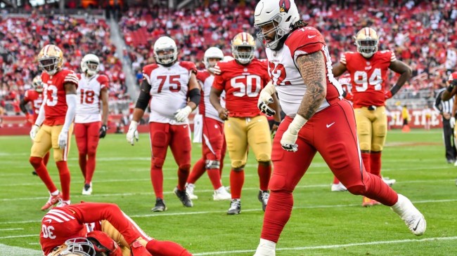 An Arizona Cardinals player tackles a 49er
