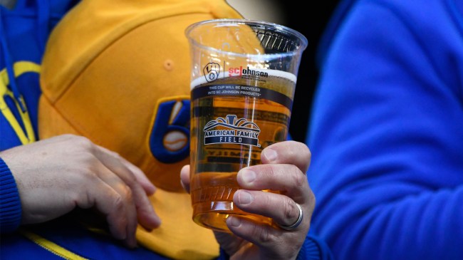 Brewers fans holding a beer an at MLB game