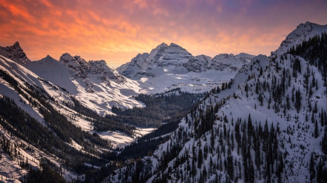 A view of the mountains with the sunset in the background.