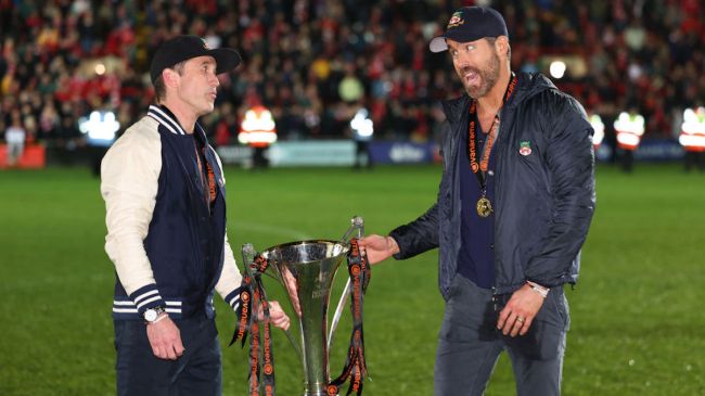 ryan reynolds and Rob McElhenney holding national league trophy