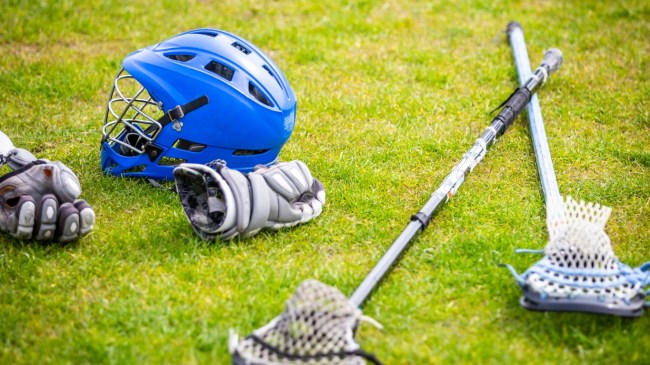 Lacrosse equipment lies on the field.