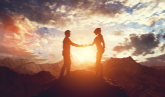 man shakes hand with alien cell phone signals