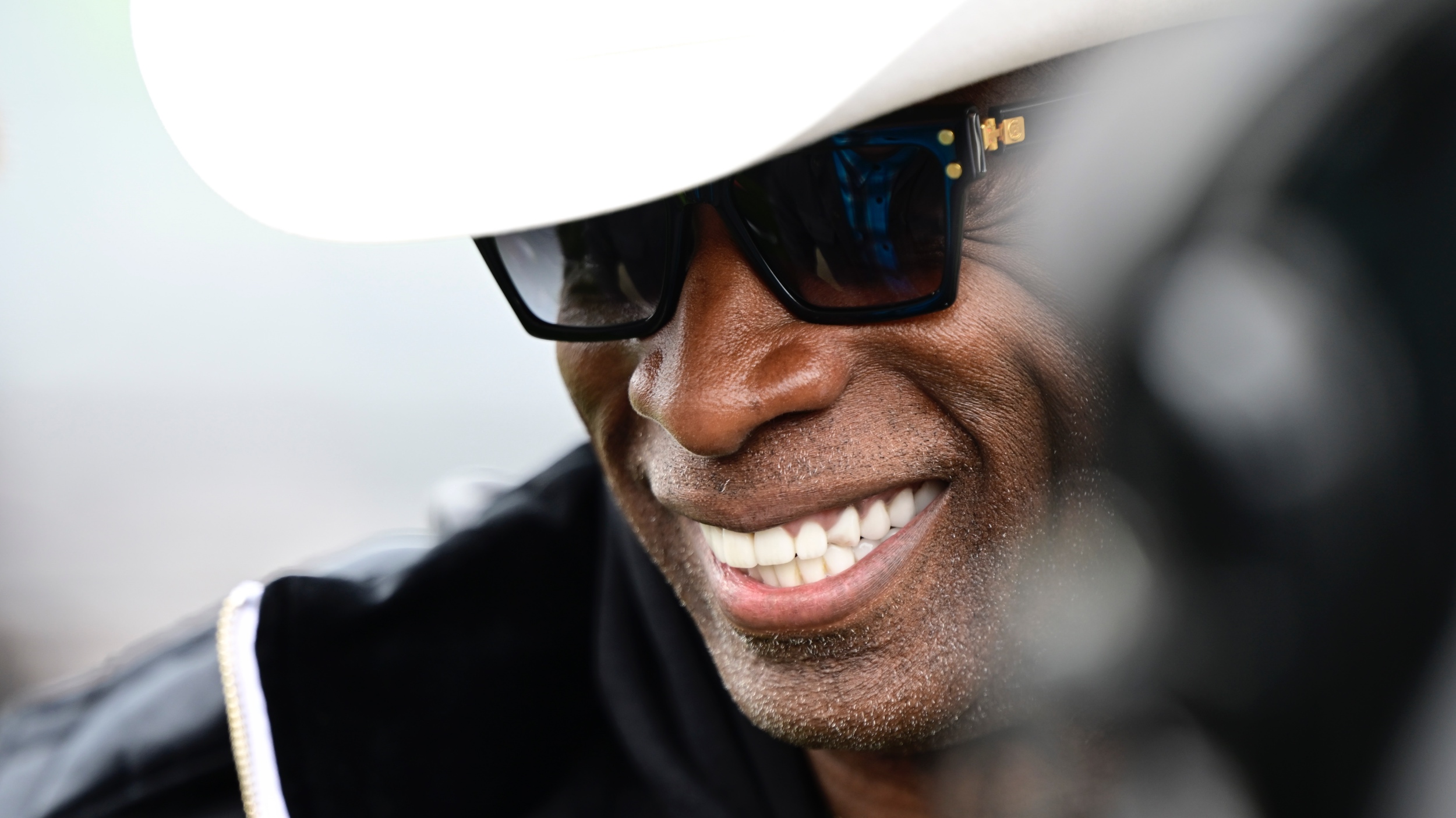 Coach Deion Sanders smiling