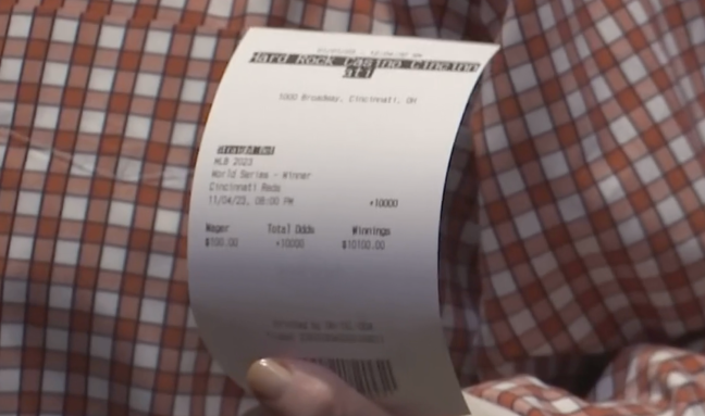 Pete Rose holding Reds World Series bet slip