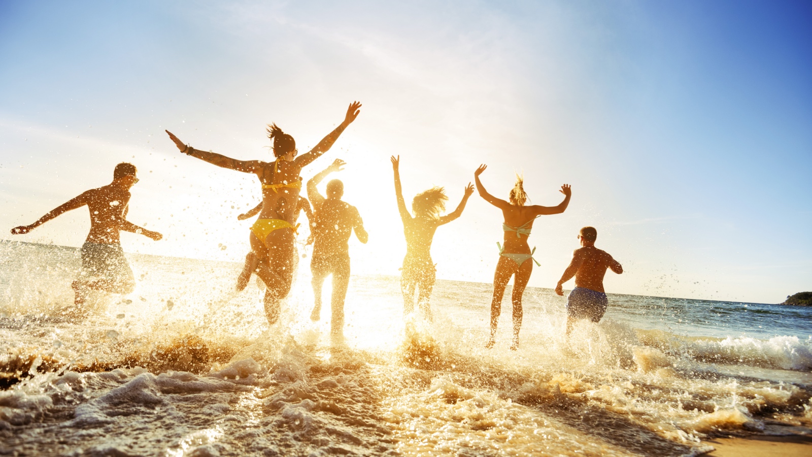 group having fun at the beach in the water